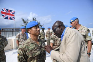 Sgt Gurung receives his UN Special Service Medal from Director Mission support UNSOS Mr Amadu Kamara